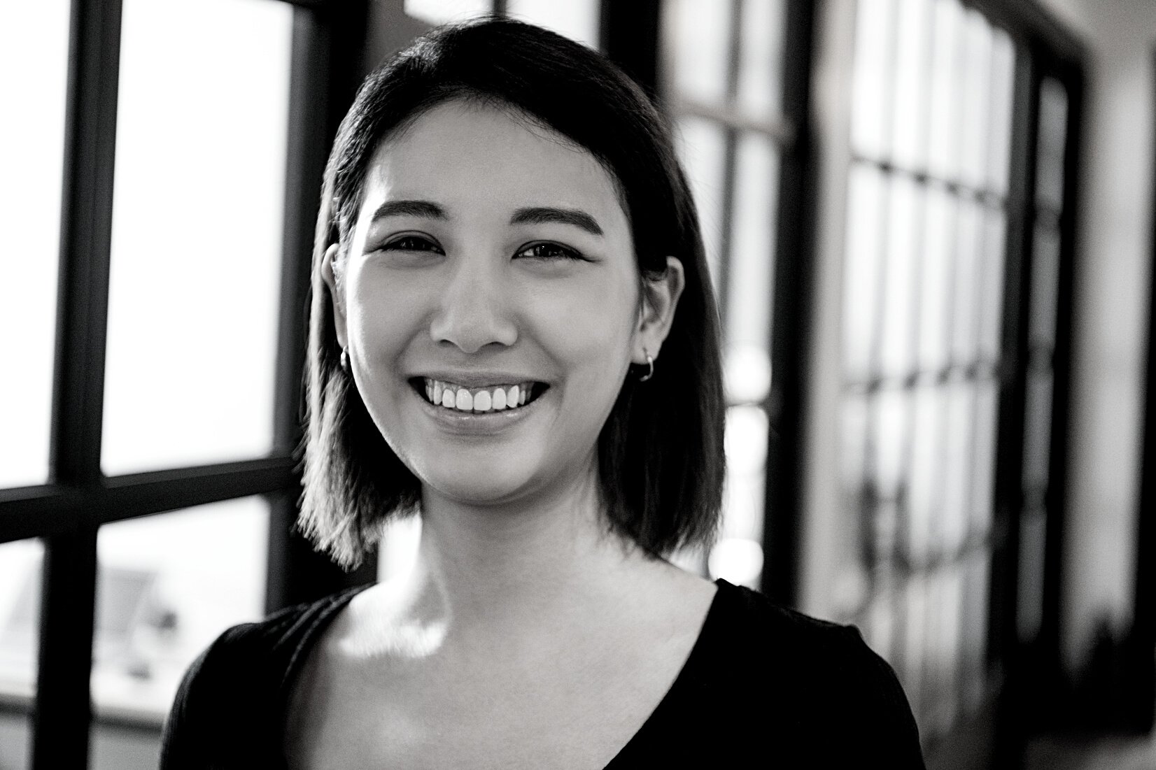 Headshot portrait of cheerful business woman smiling