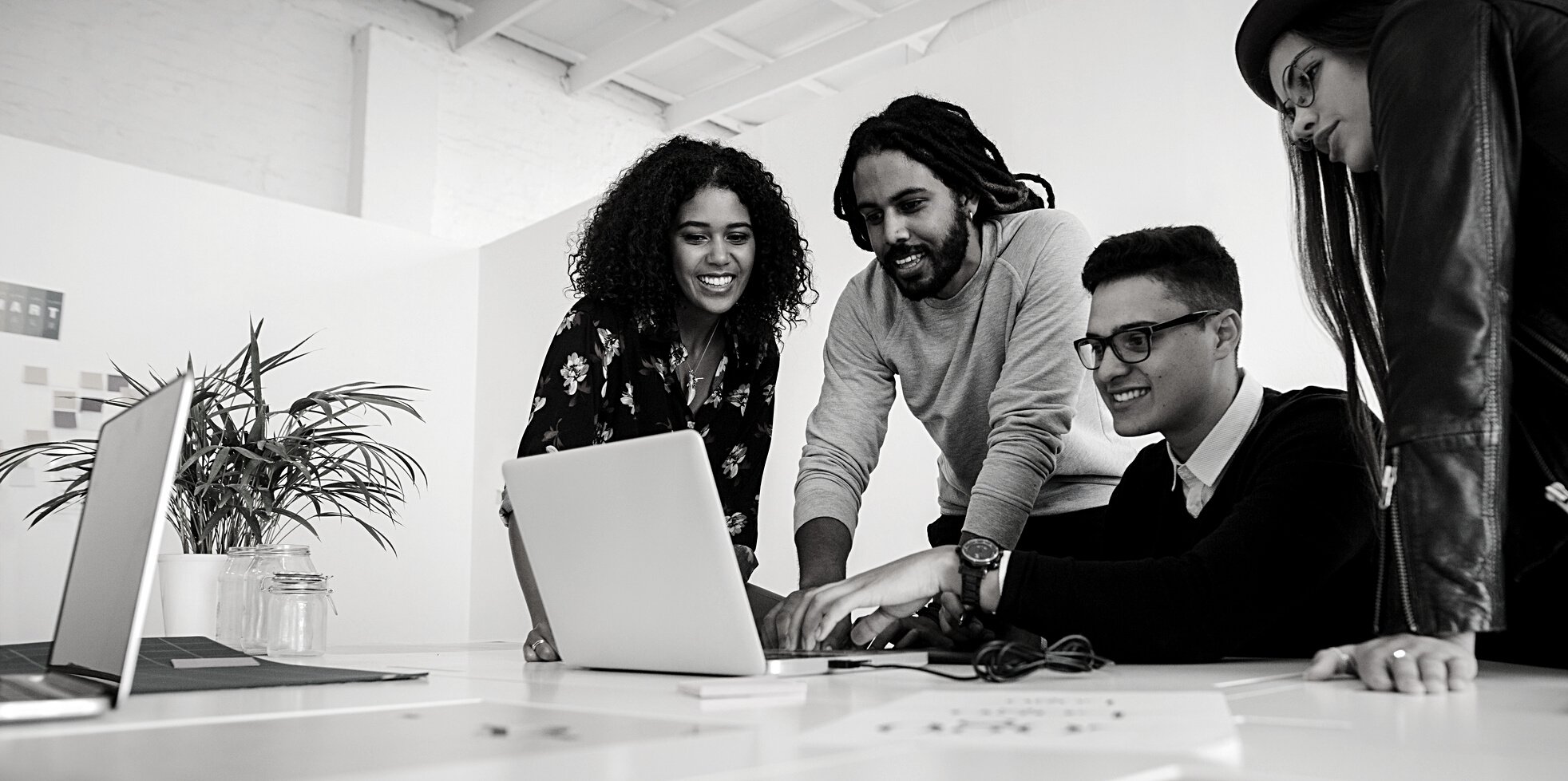 Office Mates Working Together as a Team on a Computer